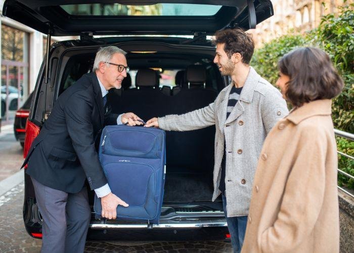 A chauffeur receives his guest from Airport in Sydney